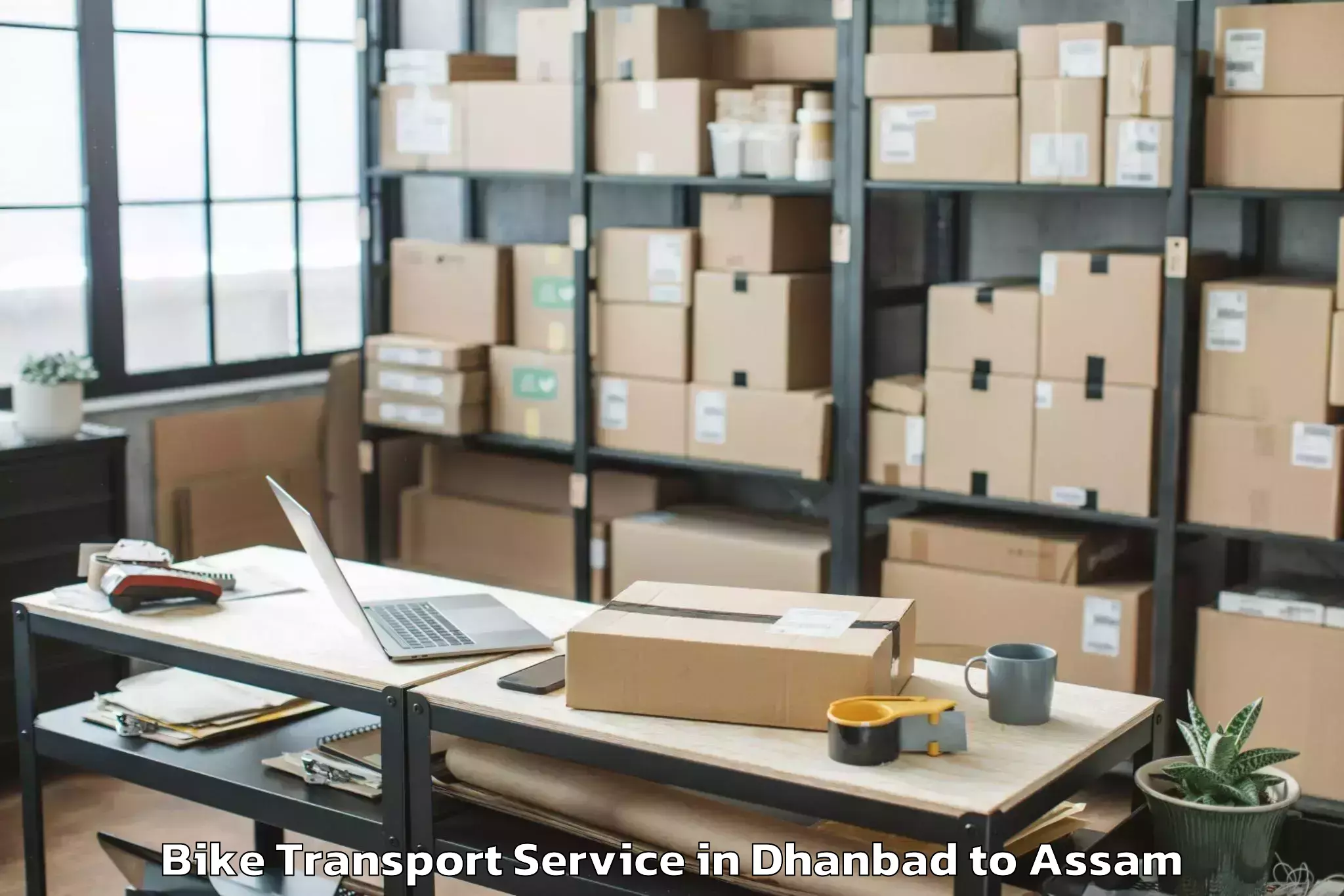 Professional Dhanbad to Khoirabari Pt Bike Transport